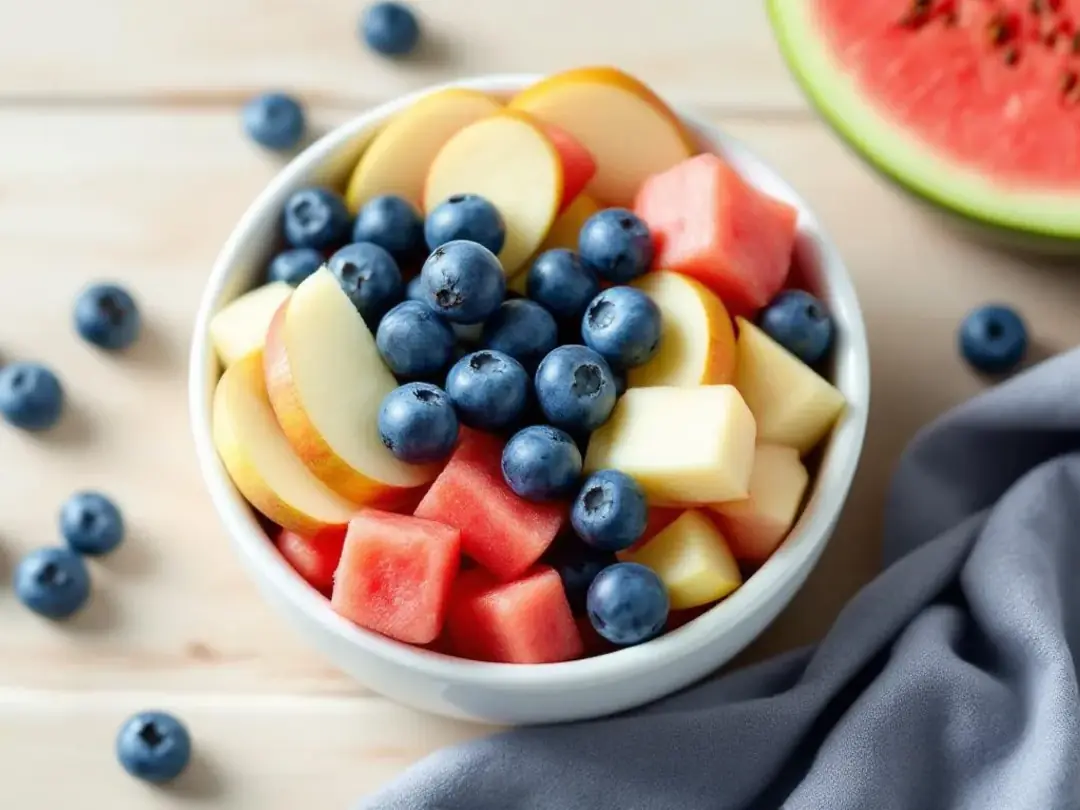 An assortment of dog-safe fruits is displayed, featuring vibrant blueberries, crisp apple slices, and juicy watermelon...