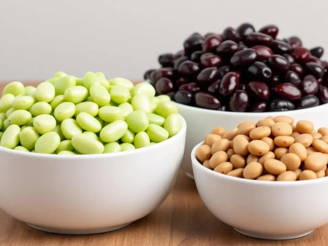 In the image, various types of cooked beans are displayed in separate bowls, featuring lima beans, black beans, green...
