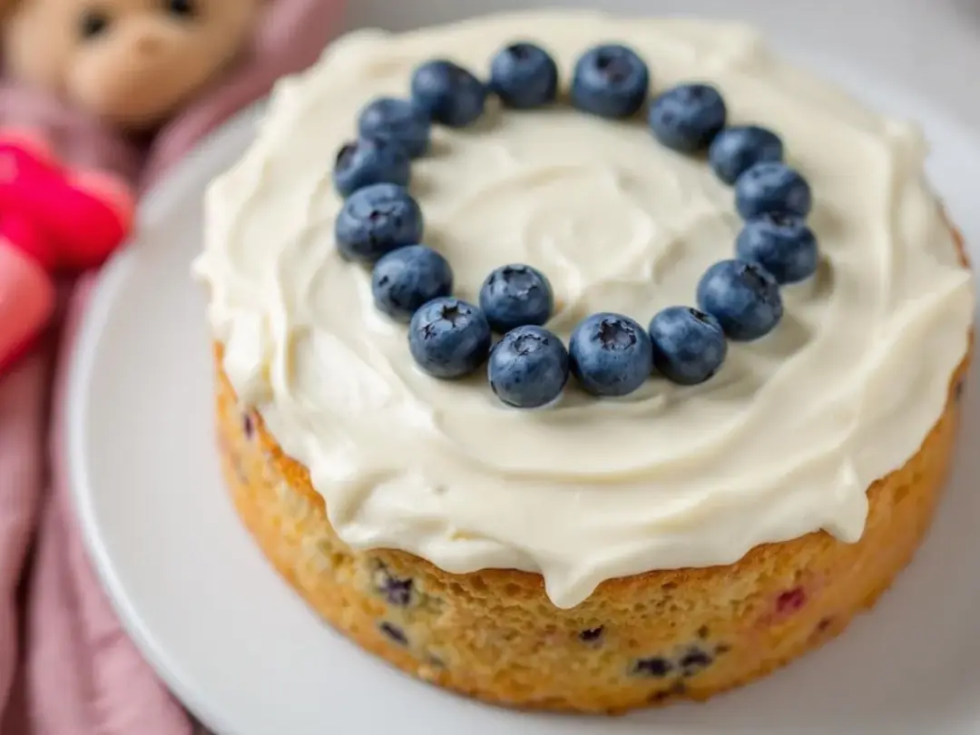 A delicious homemade dog birthday cake is decorated with a creamy plain yogurt frosting and topped with fresh...