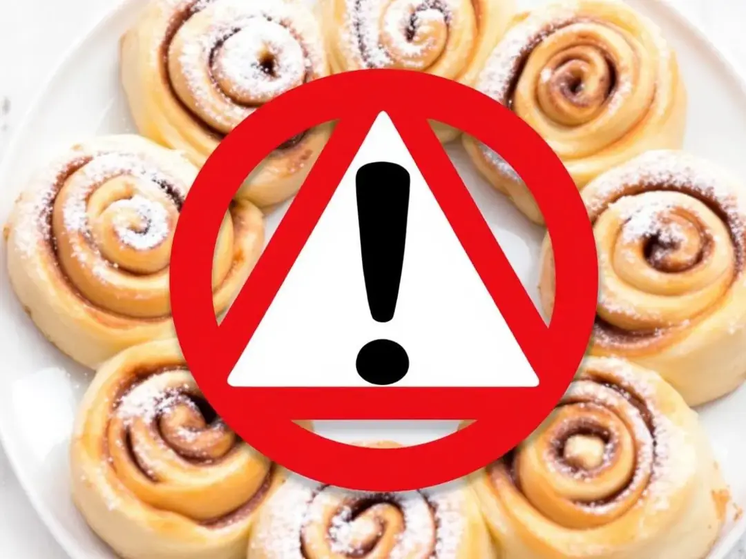 A plate of cinnamon rolls sits prominently, accompanied by a warning symbol, highlighting the message that cinnamon can...