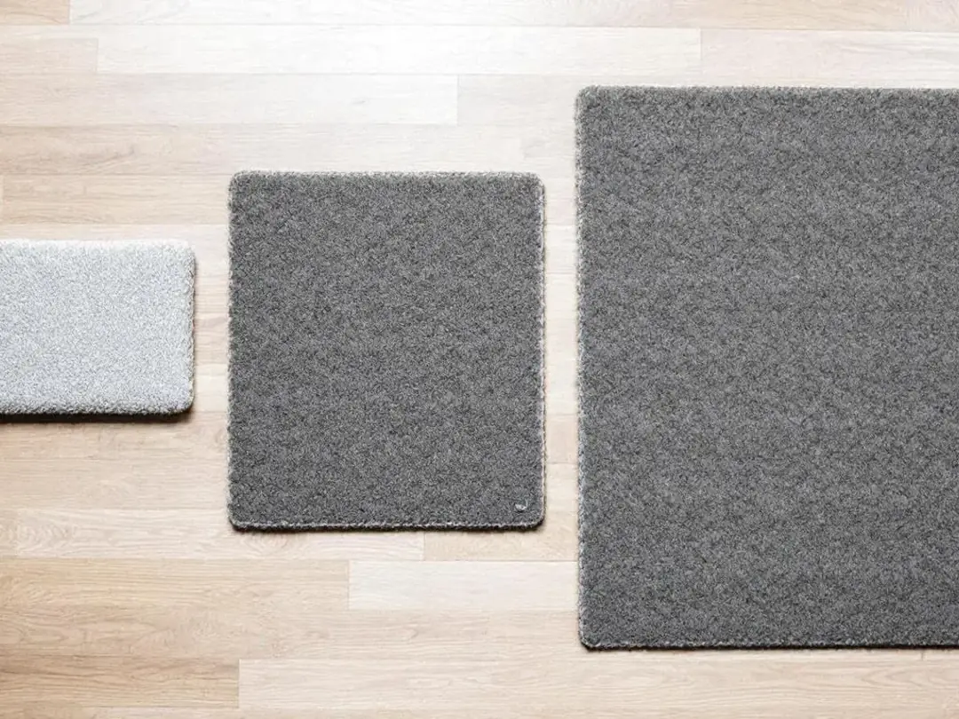 The image shows a variety of snuffle mats of different sizes laid out on a floor, highlighting their size differences...